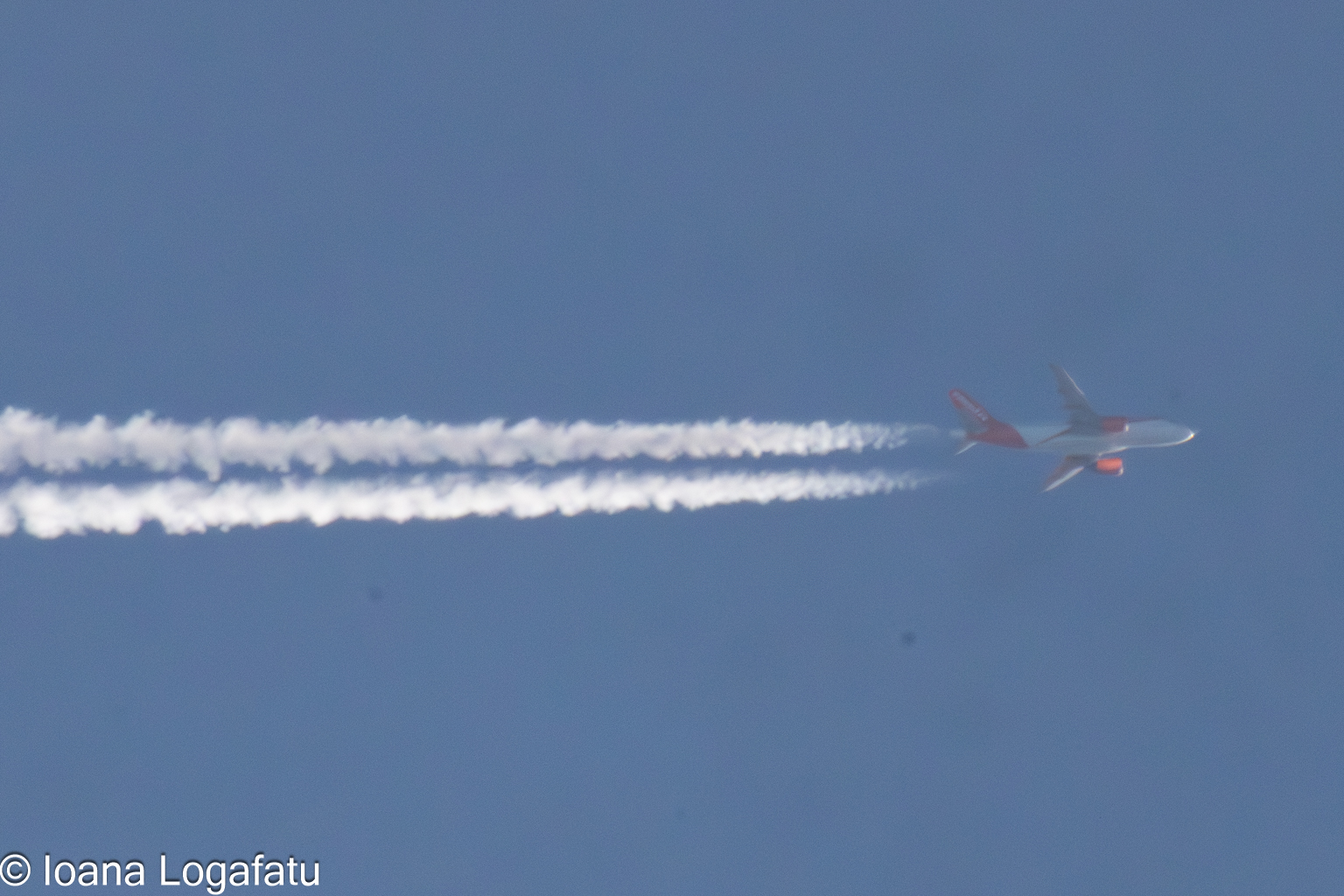 Airplane gliding through a brilliant sky trail